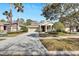 Tan house with attached garage and landscaping at 20026 Heritage Point Dr, Tampa, FL 33647
