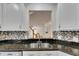 Kitchen with granite countertops, stainless steel sink, and view into the Gathering room at 20026 Heritage Point Dr, Tampa, FL 33647