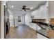 Modern kitchen with white cabinets, granite counters and tile flooring at 20026 Heritage Point Dr, Tampa, FL 33647