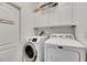 Bright laundry room with washer, dryer and cabinets at 20026 Heritage Point Dr, Tampa, FL 33647