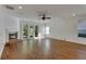 Spacious living room featuring hardwood floors, fireplace, and French doors leading to the backyard at 20026 Heritage Point Dr, Tampa, FL 33647