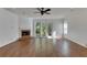 Spacious living room with hardwood floors, fireplace, and access to backyard at 20026 Heritage Point Dr, Tampa, FL 33647