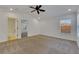 Main bedroom with carpet, ceiling fan, and access to bathroom at 20026 Heritage Point Dr, Tampa, FL 33647
