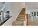 Carpeted staircase with wooden railing leading to the upper level at 20026 Heritage Point Dr, Tampa, FL 33647