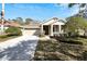 Tan house exterior with two car garage and manicured lawn at 20026 Heritage Point Dr, Tampa, FL 33647