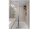 Modern walk-in shower with sleek gray tile and glass enclosure at 9658 Sweetwell Pl, Riverview, FL 33569