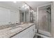 Bright bathroom with a dual sink vanity, granite countertops, and glass enclosed shower at 9658 Sweetwell Pl, Riverview, FL 33569