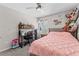 Bedroom with a pink comforter, desk, and stuffed animals at 9658 Sweetwell Pl, Riverview, FL 33569