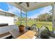 Covered patio featuring views of a landscaped backyard and a pond beyond at 9658 Sweetwell Pl, Riverview, FL 33569