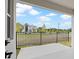 Covered patio overlooks fenced backyard with a view of neighborhood at 2013 Wild Heron Ct, Valrico, FL 33596