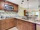 Updated kitchen featuring granite countertops and wood cabinets at 4115 Chatham Oak Ct # 218, Tampa, FL 33624