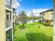 Ground level view of a grassy backyard and lake at 4115 Chatham Oak Ct # 218, Tampa, FL 33624