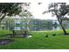 Serene lakefront view with picnic table and ducks at 4115 Chatham Oak Ct # 218, Tampa, FL 33624