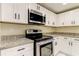 Clean kitchen with stainless steel appliances and granite countertops at 7820 Sycamore Dr, New Port Richey, FL 34654