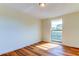 Spacious bedroom with wood-look floors and a large window at 7820 Sycamore Dr, New Port Richey, FL 34654