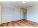 Bedroom with wood-look floors and access to a hallway at 7820 Sycamore Dr, New Port Richey, FL 34654