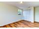 Bright bedroom with wood-look floors, large closet, and window at 7820 Sycamore Dr, New Port Richey, FL 34654
