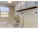 Laundry room with sink, cabinets, and window at 7820 Sycamore Dr, New Port Richey, FL 34654