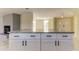 Modern kitchen island with granite countertop, white cabinets, and black hardware at 7820 Sycamore Dr, New Port Richey, FL 34654