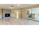 Living room with fireplace, patio access and kitchen views at 7820 Sycamore Dr, New Port Richey, FL 34654