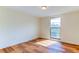 Well-lit bedroom featuring wood-look floors and a large window at 7820 Sycamore Dr, New Port Richey, FL 34654