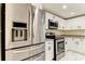 Updated kitchen with stainless steel appliances and granite countertops at 7820 Sycamore Dr, New Port Richey, FL 34654