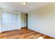 Well-lit bedroom with wood-look floors and a large closet at 7820 Sycamore Dr, New Port Richey, FL 34654