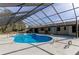 Inviting kidney-shaped pool with screened enclosure at 7820 Sycamore Dr, New Port Richey, FL 34654