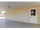 Covered back patio with access door and a view of the backyard at 7820 Sycamore Dr, New Port Richey, FL 34654