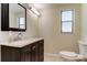 Clean bathroom with vanity, toilet, and window for natural light at 7820 Sycamore Dr, New Port Richey, FL 34654