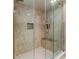 Large walk-in shower with glass enclosure and tiled walls at 7820 Sycamore Dr, New Port Richey, FL 34654