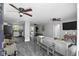 Open concept living room and kitchen with gray sofas and hardwood floors at 3007 Dixie Ave, Sarasota, FL 34234