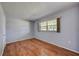 Simple bedroom with wood-look floors and a large window at 604 Park Cir # 16, Bradenton, FL 34207