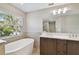 Bathroom boasts double sinks, a large soaking tub, and modern finishes at 1321 W Arch St, Tampa, FL 33607