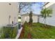 Landscaped side yard with new plantings and AC units at 1323 W Arch St, Tampa, FL 33607