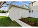 Detached storage shed with a white exterior and concrete walkway at 1323 W Arch St, Tampa, FL 33607