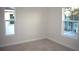 Bedroom with neutral walls, carpet, and two windows at 1939 W Arch St, Tampa, FL 33607