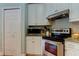 White kitchen cabinets, stainless steel appliances and granite countertops at 2409 Heather Manor Ln, Lutz, FL 33549
