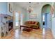 Relaxing living room with fireplace, French doors, and comfortable seating area at 2409 Heather Manor Ln, Lutz, FL 33549