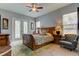 Spacious bedroom with a sleigh bed, French doors leading to the pool, and an armchair at 2409 Heather Manor Ln, Lutz, FL 33549