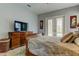 Serene bedroom with a comfortable sleigh bed and French doors opening to the pool at 2409 Heather Manor Ln, Lutz, FL 33549