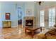 Cozy living room with stone fireplace, French doors, and comfortable seating at 2409 Heather Manor Ln, Lutz, FL 33549