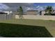 Spacious fenced-in backyard with lush green lawn, offering privacy and room to roam at 2855 Maiden Grass Isle, Wesley Chapel, FL 33543