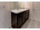 Bathroom vanity with double sinks and dark wood cabinets at 2855 Maiden Grass Isle, Wesley Chapel, FL 33543