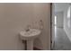 Pedestal sink with modern faucet and lighting in half-bath at 2855 Maiden Grass Isle, Wesley Chapel, FL 33543