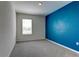 Colorful bedroom featuring a contrasting accent wall and plush carpeting at 2855 Maiden Grass Isle, Wesley Chapel, FL 33543