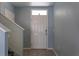 Inviting foyer with tile flooring, stairs and a view of the front door at 2855 Maiden Grass Isle, Wesley Chapel, FL 33543