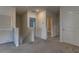 Upstairs hallway features neutral carpet and access to bedrooms and bathrooms at 2855 Maiden Grass Isle, Wesley Chapel, FL 33543