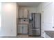 Kitchen includes stainless steel refrigerator, granite countertops, and modern cabinets at 2855 Maiden Grass Isle, Wesley Chapel, FL 33543