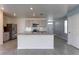 Well-lit kitchen boasts stainless steel appliances, granite countertops, and central island at 2855 Maiden Grass Isle, Wesley Chapel, FL 33543